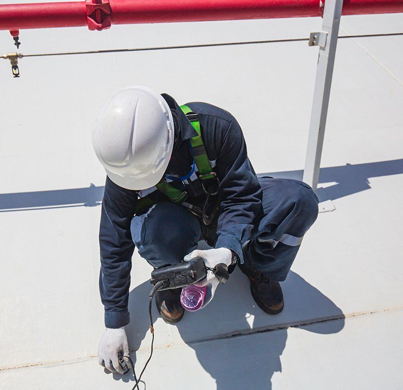 Man Inspecting Roof Thickness